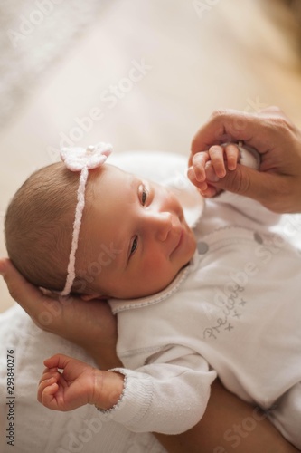 Close-up. The handle of the baby in mother's hands. Cute newborn baby sleeping in mother's arms. Motherhood.