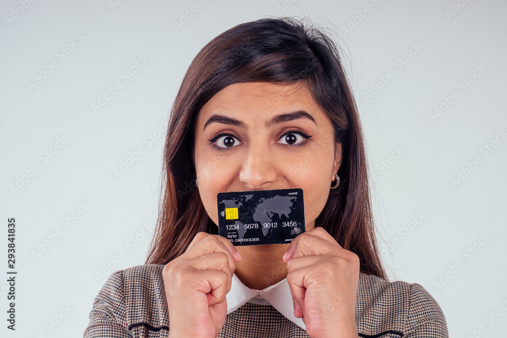 happy indian girl holding credit card in studio white background happy indian girl holding credit card in studio white background