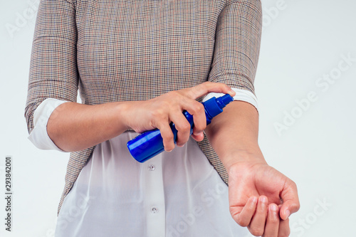 indian woman holding bottle of sun cream in studio white background