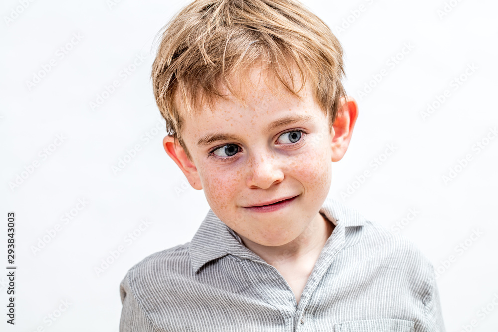 adorable boy with freckles enjoying thinking, daydreaming, white background portrait adorable boy with freckles enjoying thinking, daydreaming, white background portrait