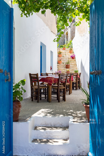 Streetview of Crete with whitewashed walls and blue doors and windows, Greece