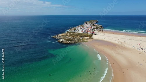 Aerial view of island Baleal naer Peniche on the shore of the ocean in west coast of Portugal. Baleal Portugal with incredible beach and surfers. Aerial footage of Baleal, Portugal. 4k quality photo