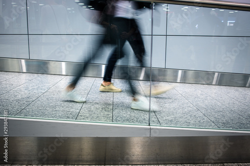 People at an international airport, before going through the check-in and the security check before their flight - motion blurred image photo