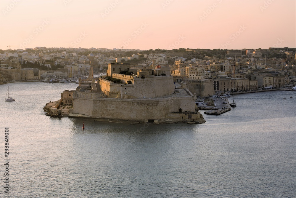 Valletta, Malta, August 2019. Fort St. Angelo in the rays of the rising sun. Valletta, Malta, August 2019. Fort St. Angelo in the rays of the rising sun.