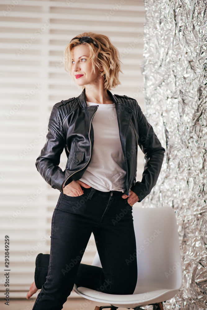 Portrait of beautiful young blonde woman with makeup in fashion clothes Portrait of beautiful young blonde woman with makeup in fashion clothes