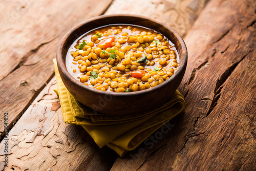 Chana Dal fry or Split Bengal Gram tadka served in a bowl or pan, selective focus