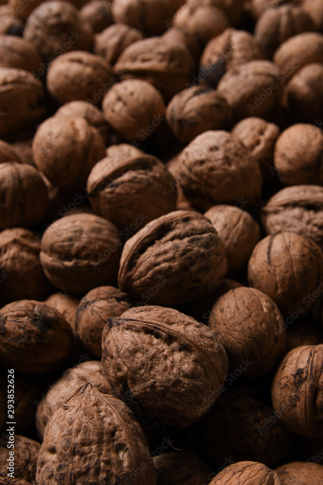 Background of fresh walnuts a lot of relief, closed, in a shell (background, pattern) from a close distance with full frame, copy space and place for text Background of fresh walnuts a lot of relief, closed, in a shell (background, pattern) from a close distance with full frame, copy space and place for text