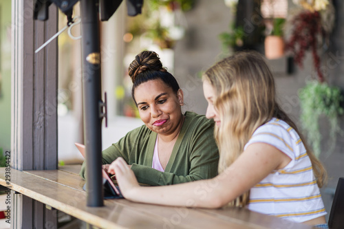 two women working together on a computer