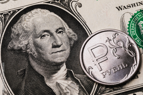 Tableau sur toile 1 ruble coin against the background of 1 dollar bill, close-up