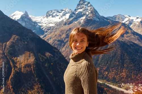 Nice Girl traveler in the background of the mountains