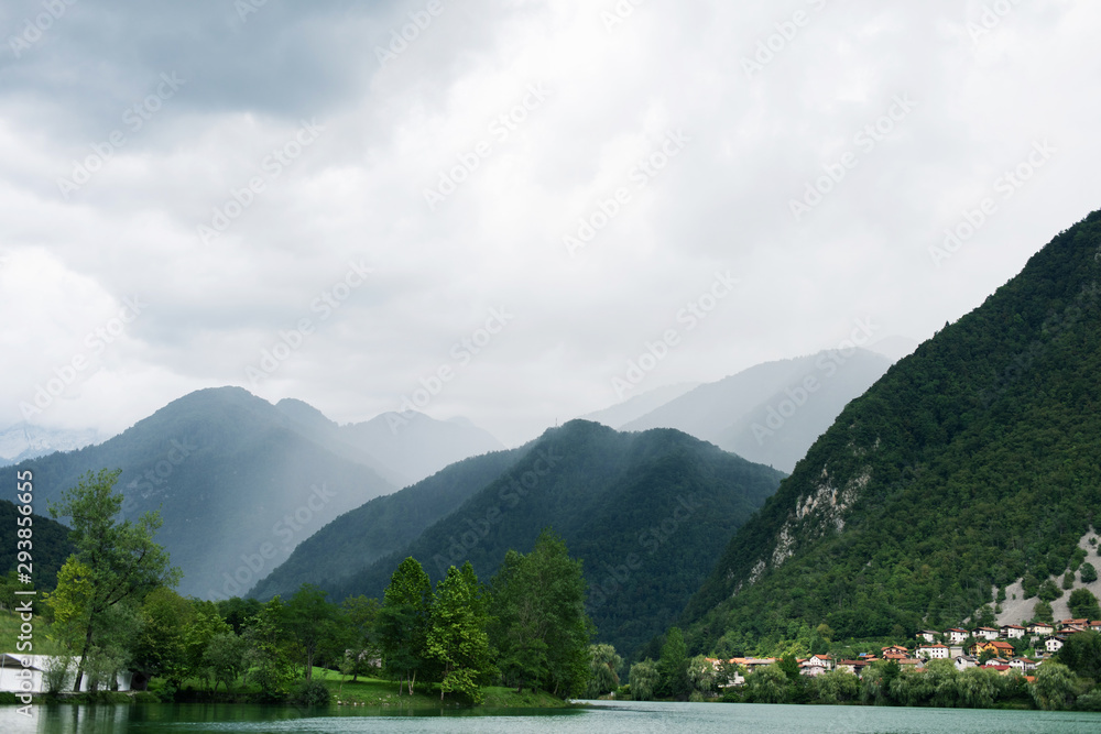 Fog over the mountains city and lake