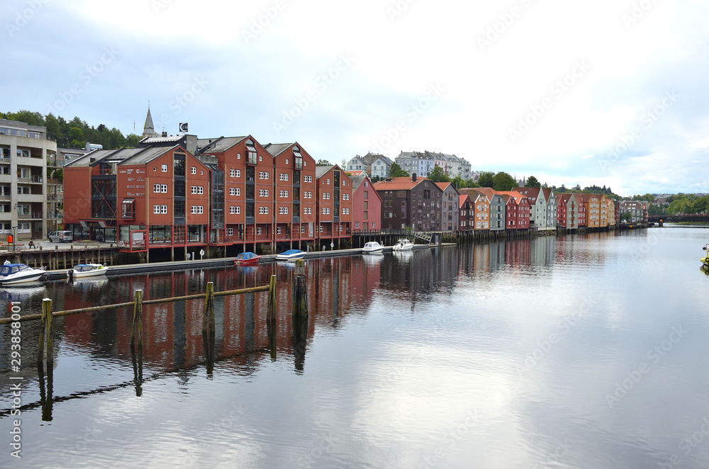 Wooden Colorful Houses Along the River in Trondheim, Norway Wooden Colorful Houses Along the River in Trondheim, Norway
