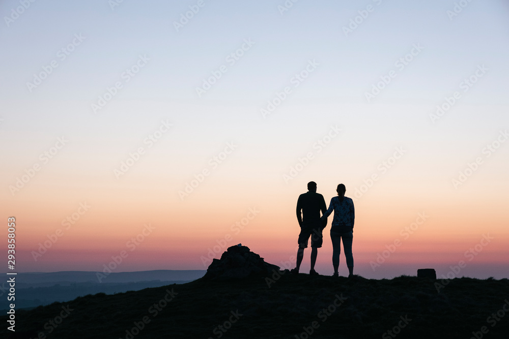Couple admiring the view at twilight from Little Longstone, Derb Couple admiring the view at twilight from Little Longstone, Derb