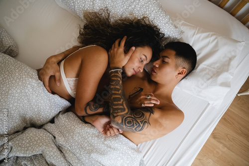 Lovers embraced in bed photo
