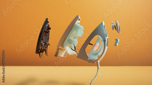 Disassembled Flatiron With Parts Floating In The Air On Orange Background photo