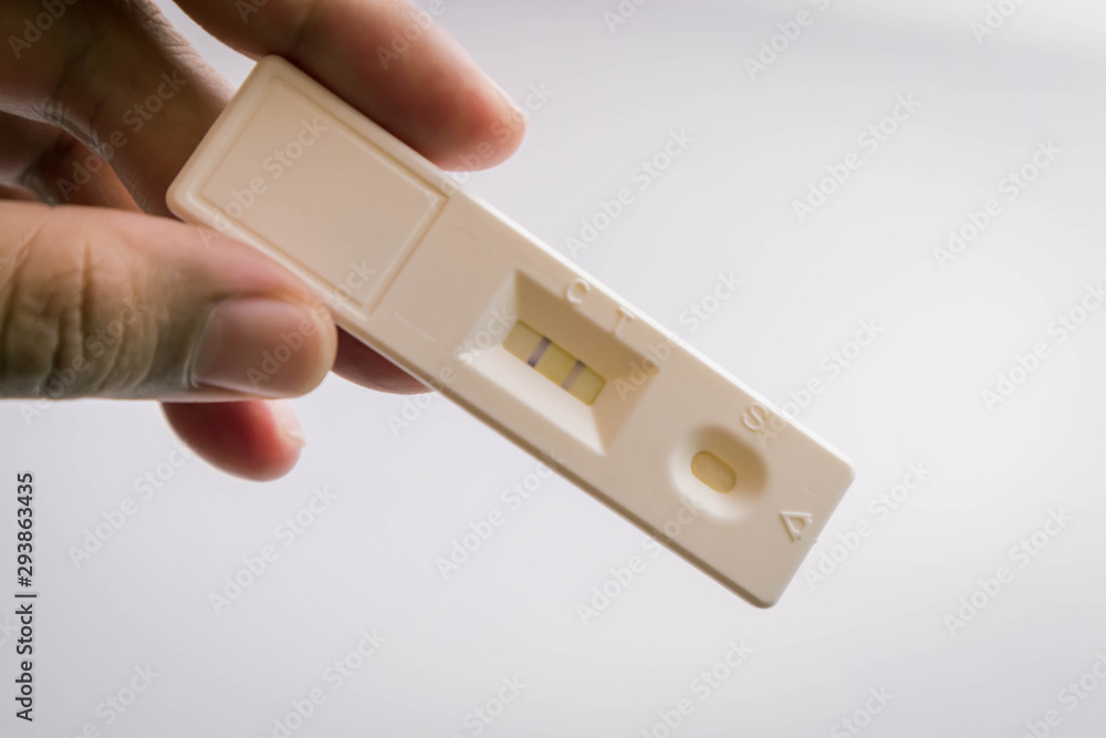 Asian hand woman holding and showing positive pregnancy tests with happiness She is about to conceive a baby, a new member of the upcoming family, the family is being filled. Asian hand woman holding and showing positive pregnancy tests with happiness She is about to conceive a baby, a new member of the upcoming family, the family is being filled.