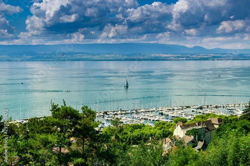 View from the viewpoint of the port of Thonon les Bains, boats, Lake Geneva, and the blue sky with clouds.Haute-Savoie in France.
