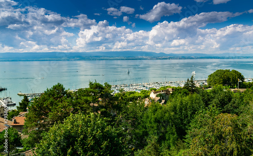 View from the viewpoint of the port of Thonon les Bains, boats, Lake Geneva, and the blue sky with clouds.Haute-Savoie in France. © mimpki
