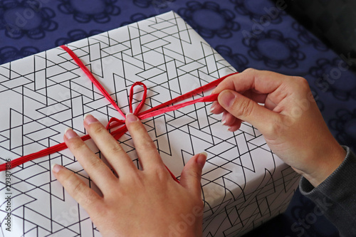 Slika na platnu female hands wrapping or unwrapping a gift pack