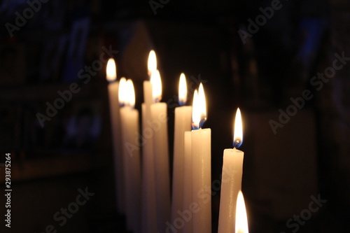 Row of lit candles on offer to the cult of the Virgin Mary (Madonna), in the cave of the sanctuary of the Mentorella, in Guadagnolo. Rome, Lazio, Italy. Sacred place of prayer, peace and silence.