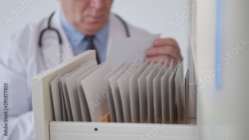 Doctor Open a Drawer and Looking for Documents in Hospital Medical Archive
