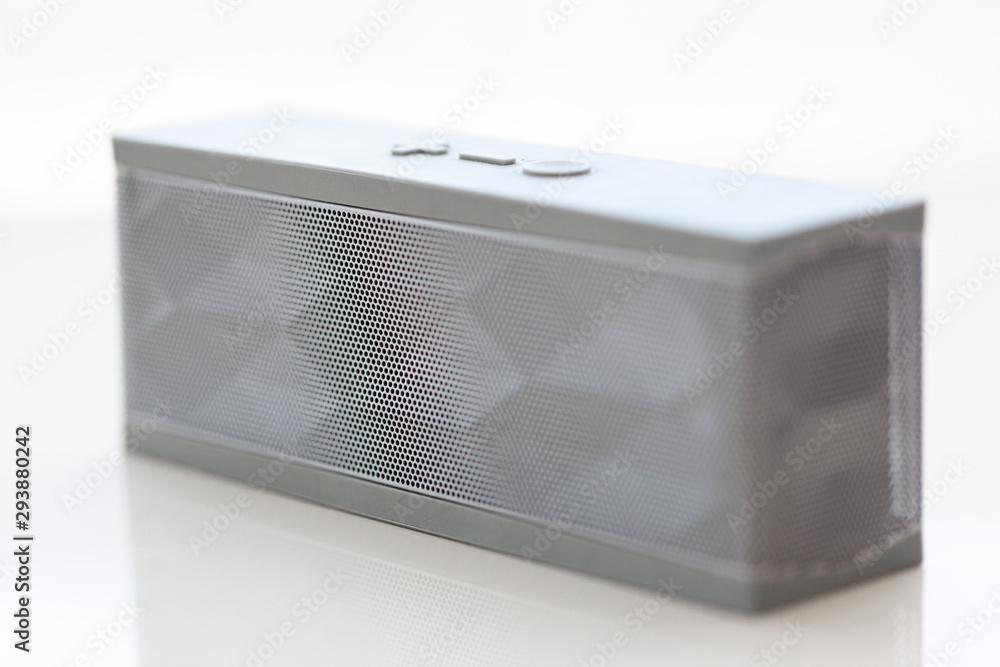 Obraz premium Modern grey bluetooth speaker white background