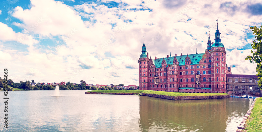 Obraz premium beautiful landscape with largest Renaissance castle in Scandinavia Frederiksborg slot Castle near Copenhagen. Hillerod, Denmark. Exotic amazing places. Popular tourist atraction.