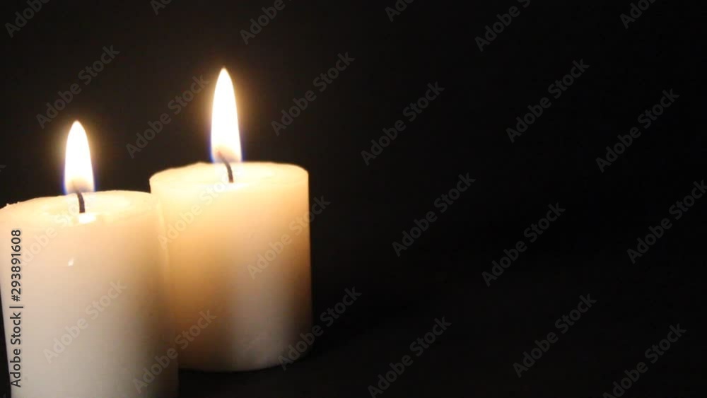 Burning candles on a black background that go out Burning candles on a black background that go out