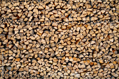 Wall of harvested firewood for the stove. Background. Texture.