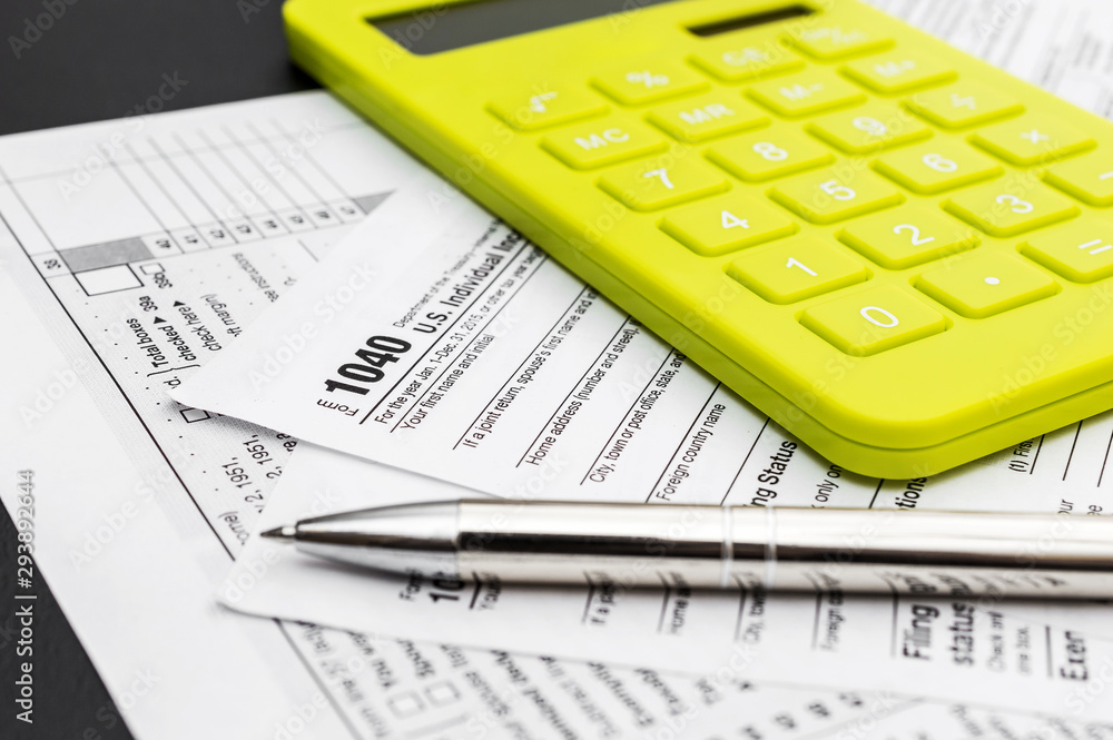 Tax forms with calculator and pen. Business and tax concept. Tax forms with calculator and pen. Business and tax concept.