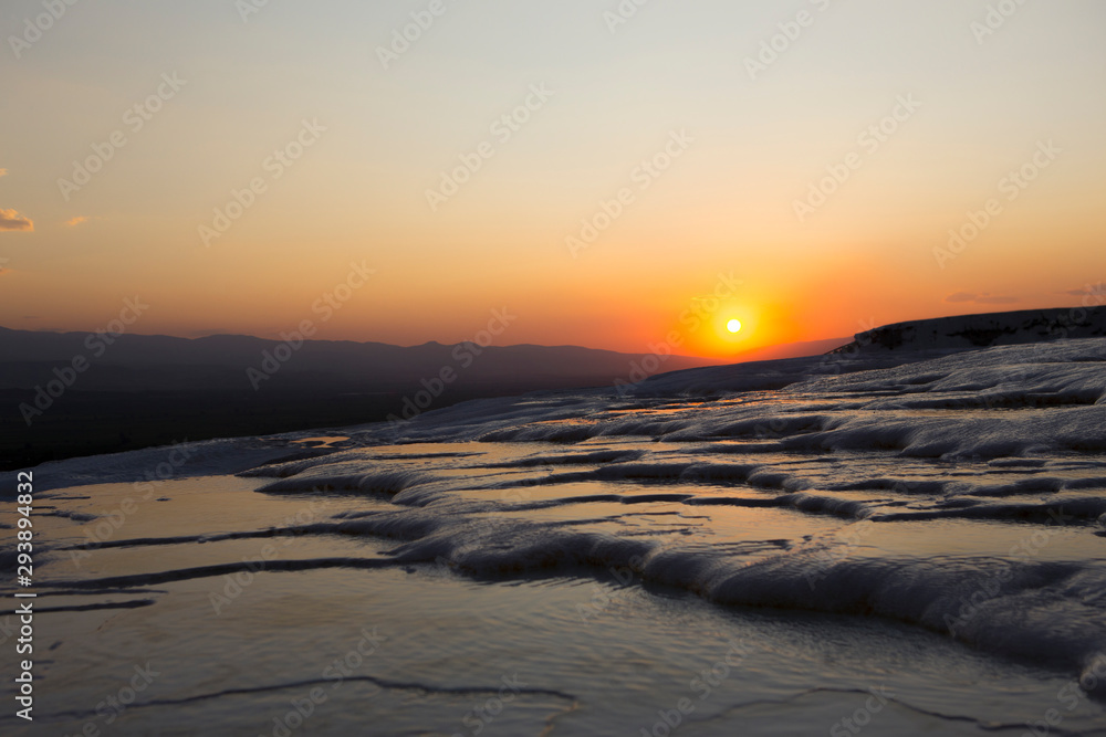 sunset view over white frozen hills