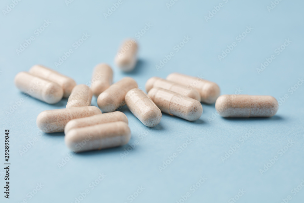 Ginkgo Biloba capsules. Dietary supplements. Bright paper background. Close up. Copy space. Ginkgo Biloba capsules. Dietary supplements. Bright paper background. Close up. Copy space.