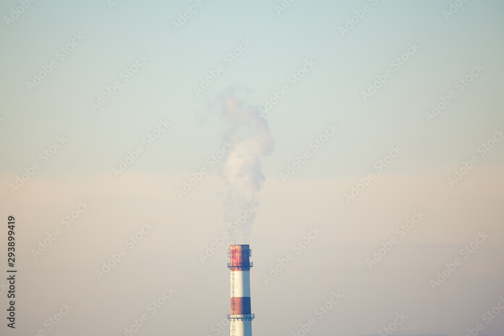 Industrial plant with smokestack on the sky