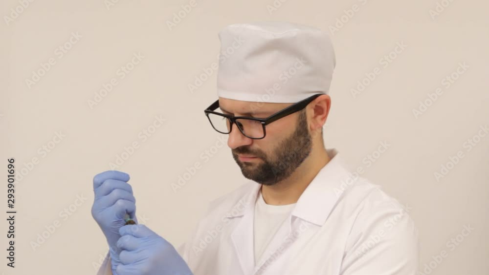 The doctor fills the syringe with medicine The doctor fills the syringe with medicine