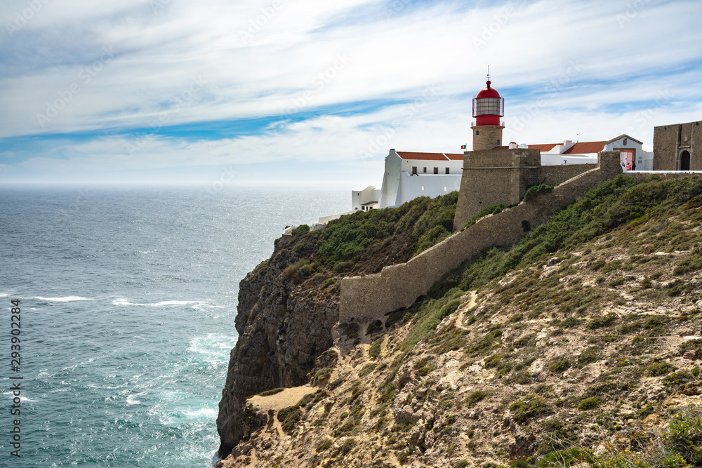 The picturesque red lighthouse on the cliffs of Cabo de Sao Vicente(Cape St. Vincent) the .southwesternmost point of Portugal, Algarve