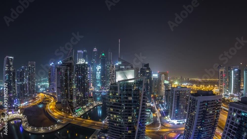 Wallpaper Mural Aerial panoramic view of Dubai Marina residential and office skyscrapers with waterfront during all night timelapse with lights switching off. Floating boats and yachts Torontodigital.ca