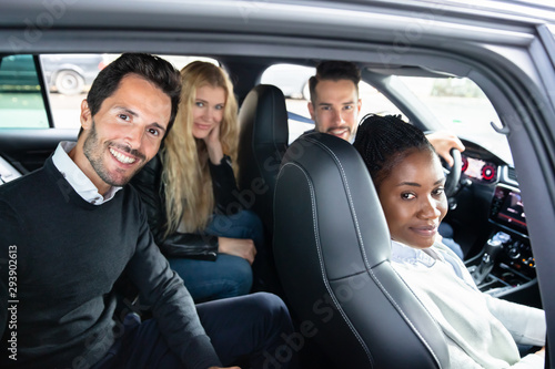 Portrait Of Multi Racial Friends Sitting In Car