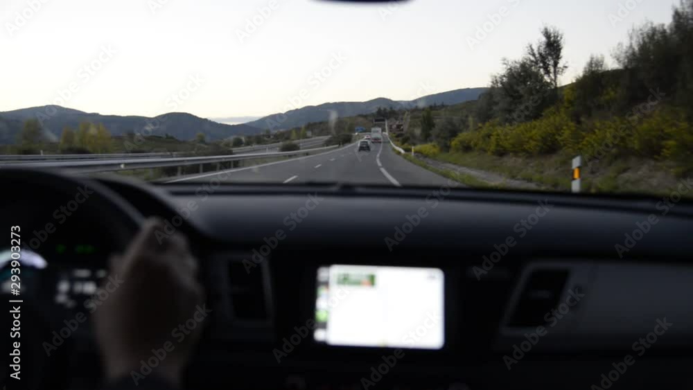 man's hand behind the wheel and views of the road man's hand behind the wheel and views of the road