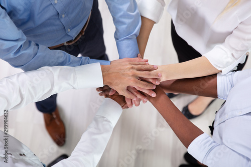 Multiracial Businesspeople Stacking Hands Over Each Other
