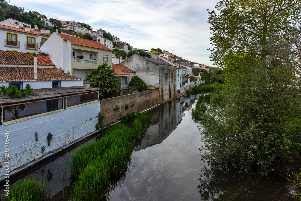Houses reflecting in a river in the small town of Aljezur, Algarve, Portugal,