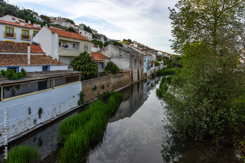 Houses reflecting in a river in the small town of Aljezur, Algarve, Portugal,