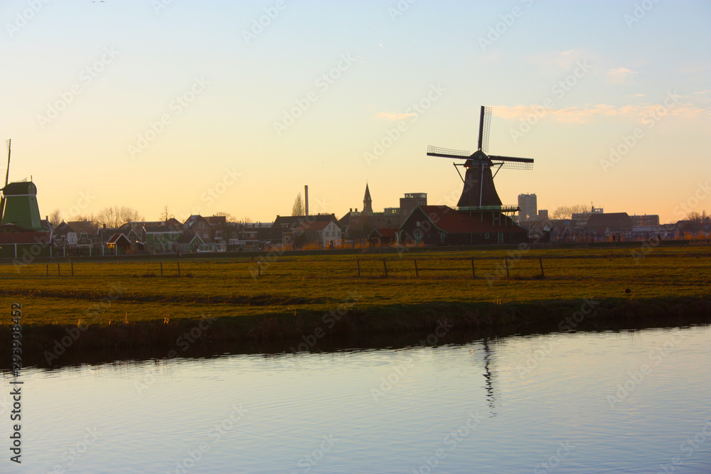 romantic sunset in red and yellow colors. the plain of the rural countryside of zaanse schans with its typical Dutch mills