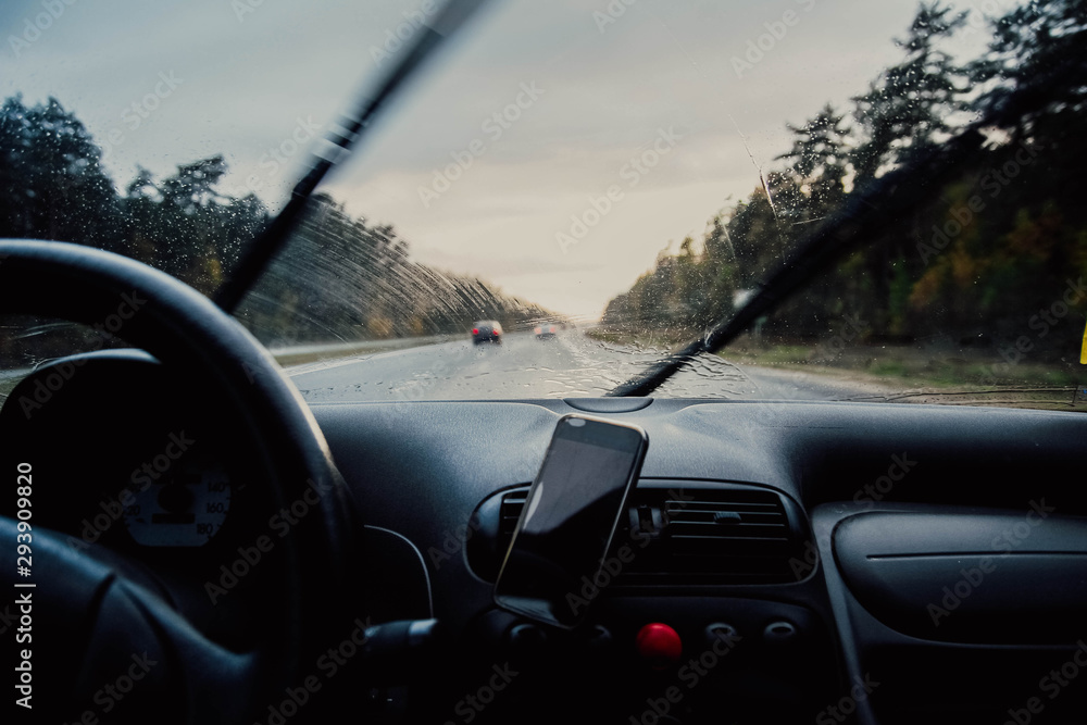 Driving a car in the fall on a sunny day in the rain. Business trip .