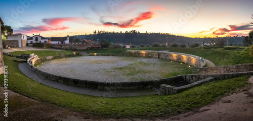 Panorama of the Roman Amphitheater of Bobadela, Oliveira do Hospital, Portugal, after sunset with a sky full of colors. photo