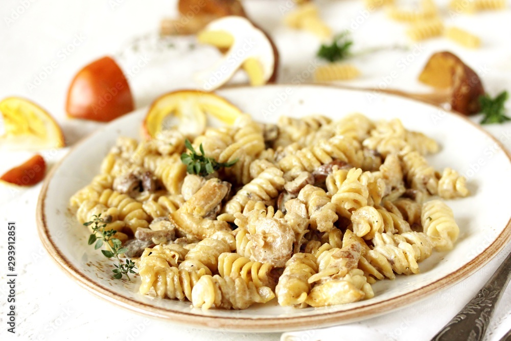 Fusilli paste with mushrooms Amanita Caesarea and boletus mushrooms and with cream. a family of fly-agarics of the highest category, a delicious mushroom. Italian Cuisine. Fusilli paste with mushrooms Amanita Caesarea and boletus mushrooms and with cream. a family of fly-agarics of the highest category, a delicious mushroom. Italian Cuisine.