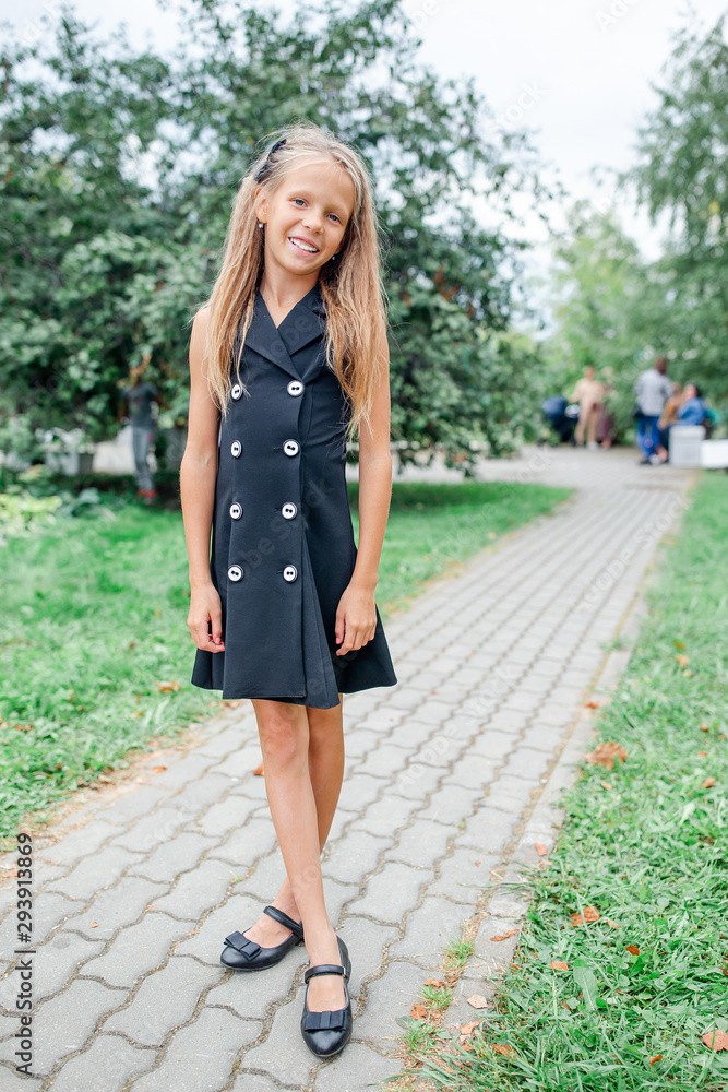 Happy school girl posing in school ourdoors Happy school girl posing in school ourdoors