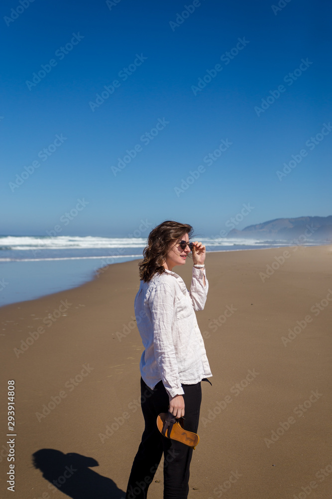 Shot of an attractive young woman on the beach of the Oregon coast near Lincoln City.