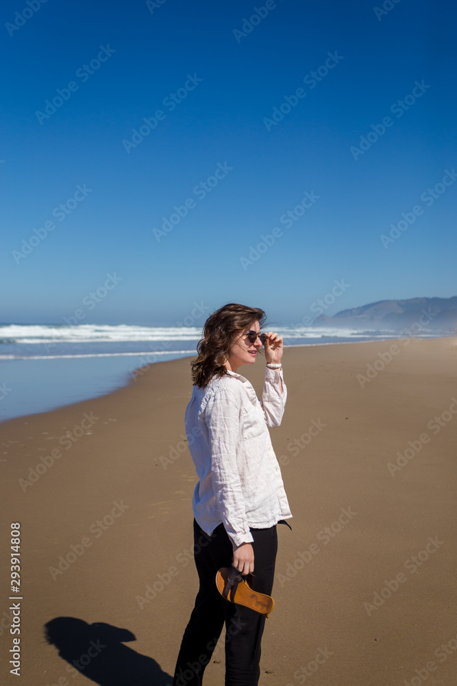 Shot of an attractive young woman on the beach of the Oregon coast near Lincoln City. Shot of an attractive young woman on the beach of the Oregon coast near Lincoln City.