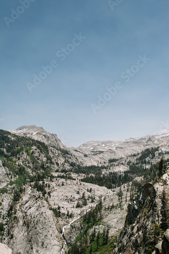 Expansive view of river running through granite rock and forest terrain in Sequoia National Park in Sierra Nevada mountains, California © Elena