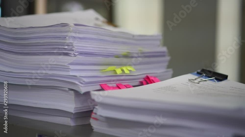 Piles unfinished documents reports files with sticky notes, overwork paper corner on teacher school desk office at university. Stack of messy paperworks assessment legal folder at workplace